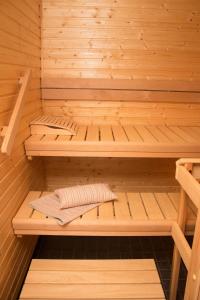 a wooden sauna with two beds in it at Deluxe Apartment with Lake View and Sauna, Lahti in Lahti