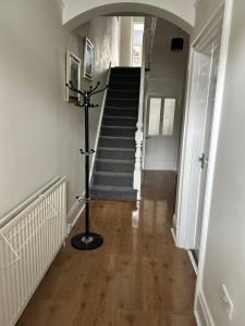 a hallway with a spiral staircase with a stair case at Huge 5 bed on the edge of Shildon in New Shildon
