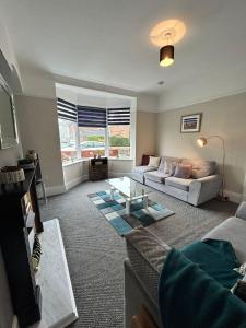 a living room with a couch and a table at Huge 5 bed on the edge of Shildon in New Shildon