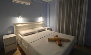 a bedroom with a white bed with a towel on it at Central Park Apartment in Tivat +8 photos