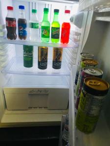 an open refrigerator filled with bottles of soda and drinks at SEBASTIAN TRANSIT KATUNAYAKE in Katunayake