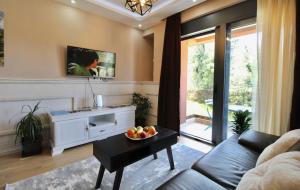 a living room with a couch and a table at Central Park Apartment in Tivat