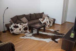 a living room with a couch and a table at Deluxe Apartment with Lake View and Sauna, Lahti in Lahti