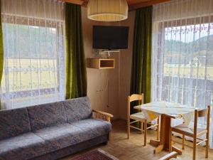 a living room with a couch and a table at Haus Schweighofer in Neuberg an der Mürz