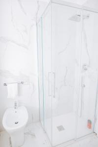 a white bathroom with a shower and a toilet at Authentic Italian Home in Griante Cadenabbia