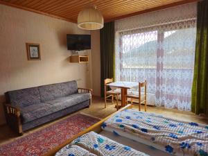 a living room with a couch and a table at Haus Schweighofer in Neuberg an der Mürz