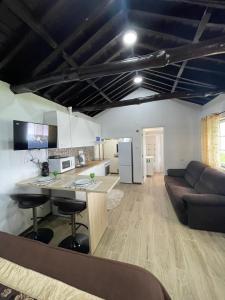 a kitchen and living room with a table and a couch at Casa da Avó Couta in Angra do Heroísmo