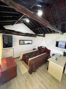 a bedroom with a bed and a tv in it at Casa da Avó Couta in Angra do Heroísmo