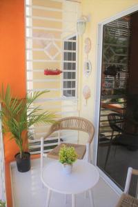 聖弗朗西斯科德馬科里斯的住宿－Apartamento Equipado, Wifi, AC, TV @drvacationsrental，门廊上的白色桌子和椅子