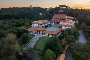 an overhead view of a building with a sunset in the background at Caucaia do Alto in Cotia