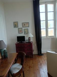 a living room with a desk and a window at Castel La Bergerie in Laglorieuse