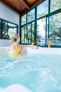 a woman sitting in a hot tub in a house at Villages Clubs du Soleil - ORCIERES in Orcières
