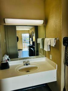 a bathroom with a sink and a large mirror at Travel Inn Bristol near State Street in Bristol