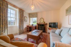 a living room with a couch and a table at Townend Farmhouse - Ullswater in Watermillock