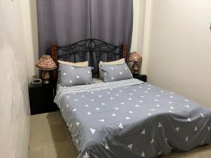 a bedroom with a bed with blue sheets and pillows at Luxurious two bathroom apartment Paramaribo, Zorg en Hoop in Paramaribo