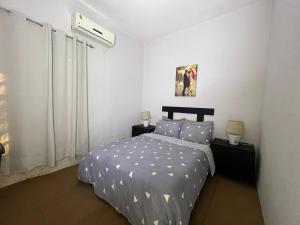 a bedroom with a bed in a white room at Luxurious two bathroom apartment Paramaribo, Zorg en Hoop in Paramaribo