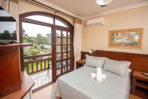 Un pat sau paturi într-o cameră la Hotel Pousada do Bosque