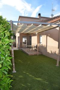 a house with a patio with a picnic table at Casa Santa Creu - Private family villa in nature in Piera