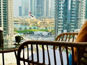 a balcony with a table and chairs and a view of a city at Burj Crown - Spectacular Boulevard View, Opposite Dubai Mall in Dubai +49 photos