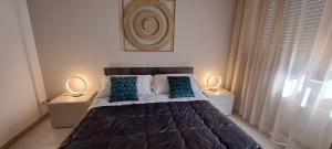 a bedroom with a large bed with blue pillows at Kalurya in Lecce