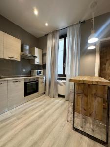 a kitchen with wooden floors and a large window at Cantore 20 in Verona