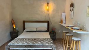 a bedroom with a bed and two stools in it at Bioevoluir in Igaratá