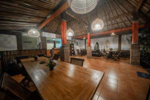 a dining room with a wooden table and chairs at Olo Surf Nature in Uluwatu