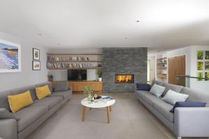 a living room with a couch and a fireplace at Treheyl, Pentire, Newquay in Newquay