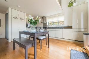 a kitchen with a table and chairs in a room at The Henley Retreat in Henley on Thames