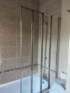 a bathroom with a shower with a tub and a toilet at Lovely 2-Bed House in Liverpool in Liverpool