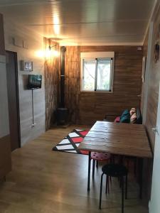 a tiny house with a table and a small child laying on the floor at K Hermaioni in Xàtiva