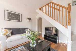 a living room with a white couch and a staircase at Stunning Character House In The Centre of Henley in Henley on Thames