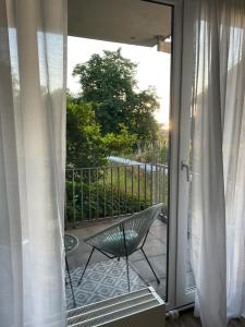 a sliding glass door with a chair on a patio at Zentrale, 55m2, helle 2 Zimmer Whg nähe Messe in Düsseldorf