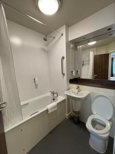 a bathroom with a toilet and a sink and a mirror at Highland Gate, Stirling by Marston's Inns in Stirling