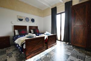 a bedroom with a bed and a large window at Charming and Tranquil House in Għasri +32 photos