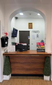 a counter in a store with a cash register at Abbey Hotel in Leicester