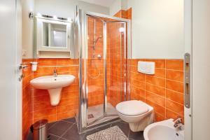 a bathroom with a shower and a toilet and a sink at Loft Santa Giulia in Turin