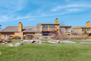 an exterior view of a large house with a yard at Saltbox 12B in White River Junction