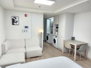 a living room with a couch and a table at Sokcho Summitbay 1402 "Ocean View" in Sokcho