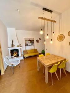 a living room with a table and chairs and a fireplace at Casa Piano Piccolo 3 in Vieste