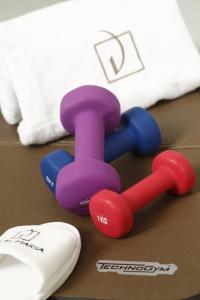 a pair of dumbbells on a table next to a keyboard at Dar El Marsa Hotel & Spa in La Marsa
