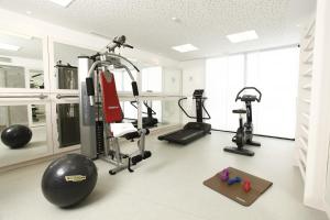 a gym with several tread machines and a treadmill at Dar El Marsa Hotel & Spa in La Marsa
