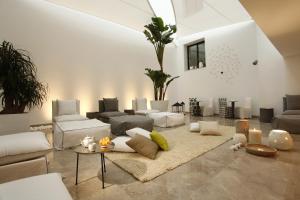 a living room with a couch and a table at Dar El Marsa Hotel & Spa in La Marsa