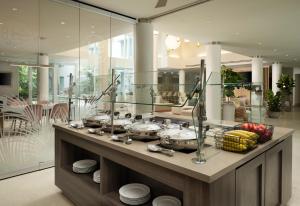 a bathroom with a counter with three sinks in it at Residence Inn by Marriott Miami Beach Surfside in Miami Beach