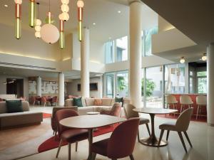 a lobby of a hospital with tables and chairs at Residence Inn by Marriott Miami Beach Surfside in Miami Beach