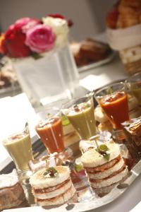 a tray of sandwiches and drinks on a table at Dar El Marsa Hotel & Spa in La Marsa