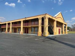 un estacionamiento frente a un gran edificio en Motel 6 Forsyth, GA Tift College, en Forsyth