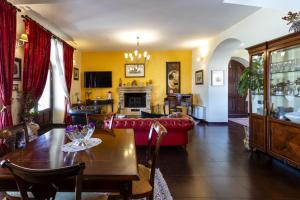 Una sala de estar con un sofá rojo y una mesa. en Villa Alike - IsulaTravel, en Módica