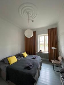 a bedroom with a large bed with yellow pillows at Tastecelebration Residence in Andrarum-Brosarp