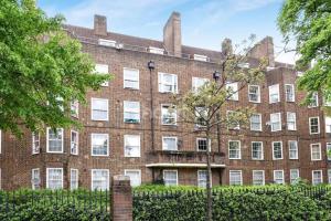 a large red brick building with white windows at Cosy 3BD London accommodation for 6 / 6 beds in London